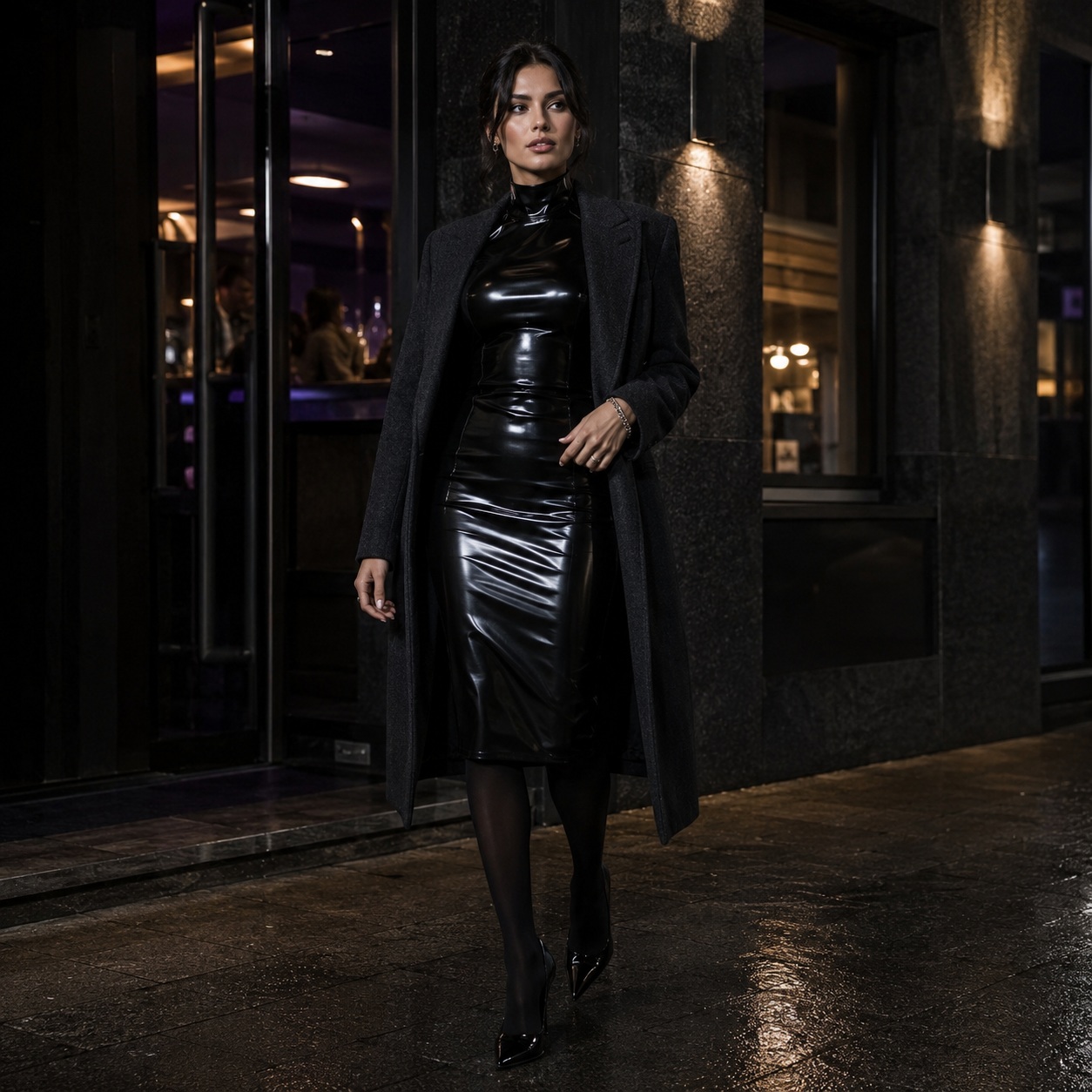 A woman in black latex and a dark coat outside after dark.